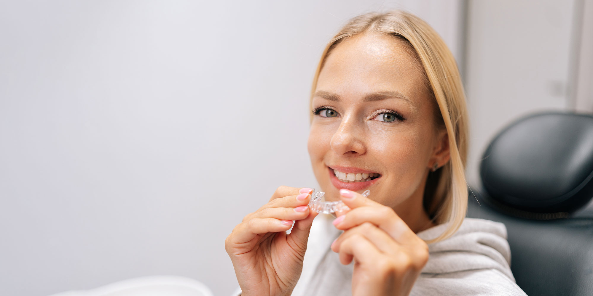 invisalign retainer being tried on hero