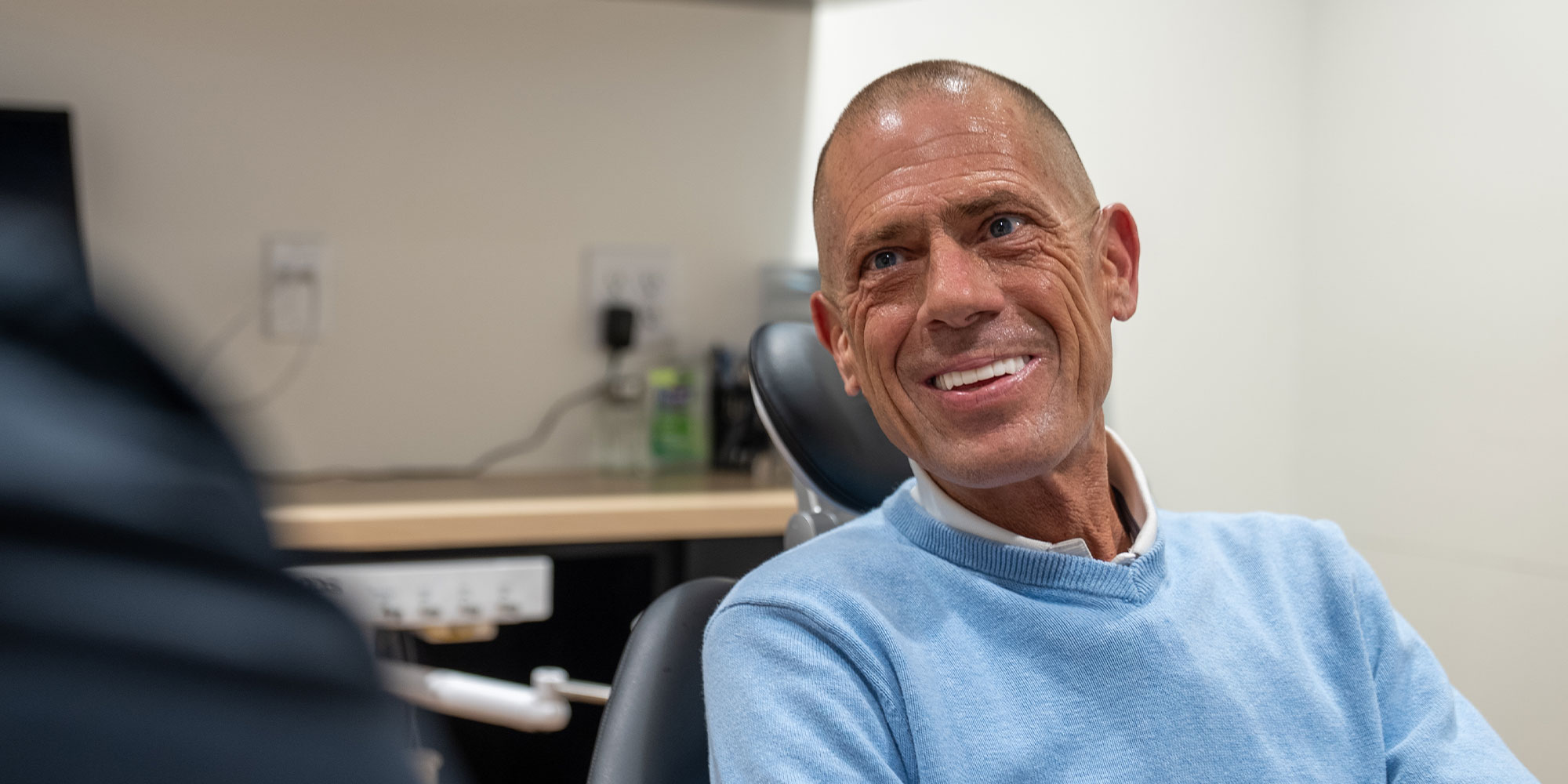 man with brand new teeth light blue shirt